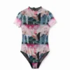 Body in tulle fantasia a maniche corte Body in tulle fantasia a maniche corte