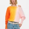 Pantaloni jeans con impunture a fiori