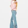 Pantaloni jeans con impunture a fiori
