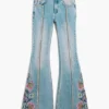Pantaloni jeans con impunture a fiori